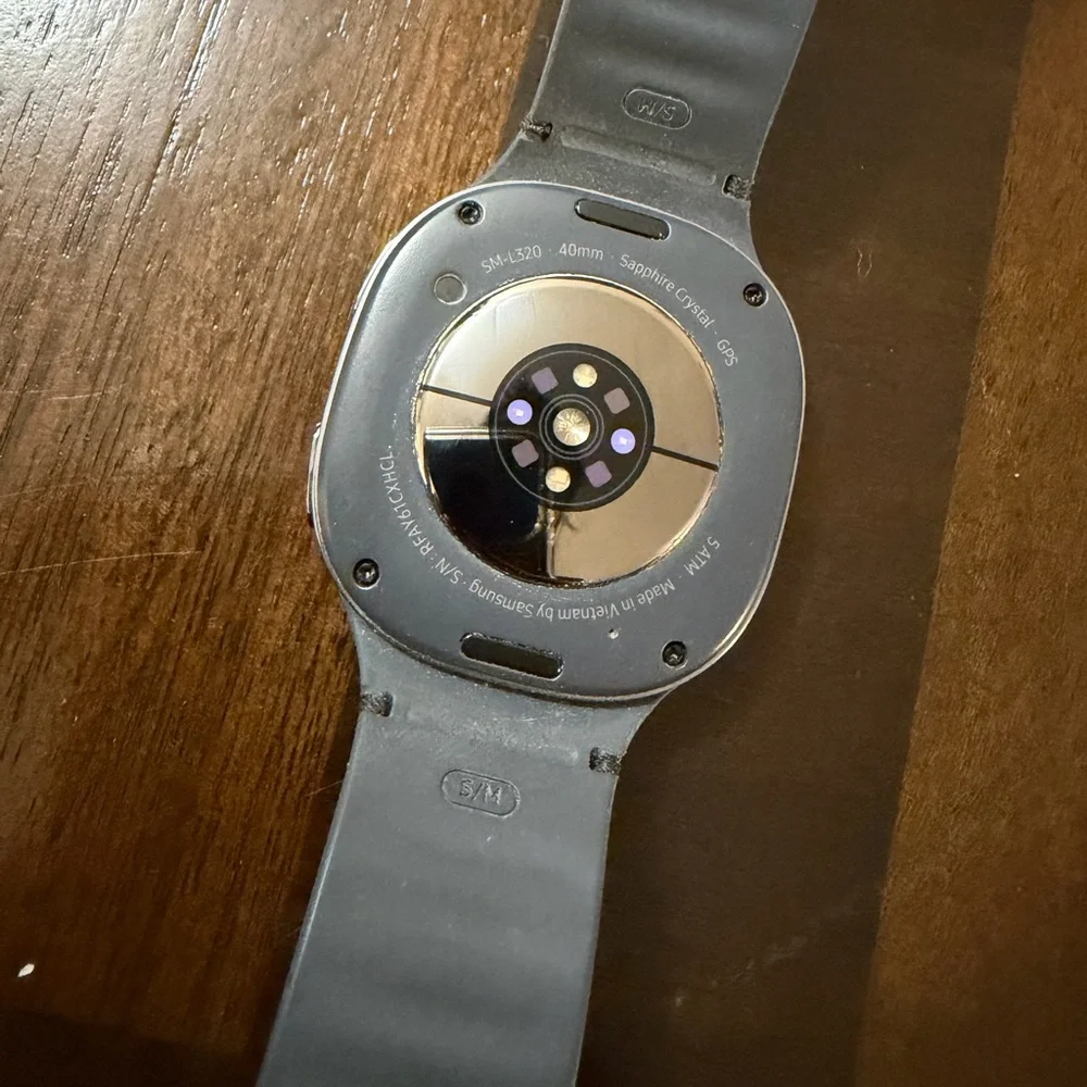 Samsung Smartwatch with Gray Band and Charging Cable
